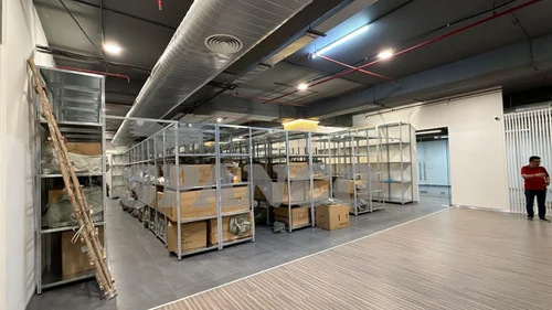 Multi-tier storage racking installed in a customer stockroom, with mesh-sided bays and MS panel decking.
